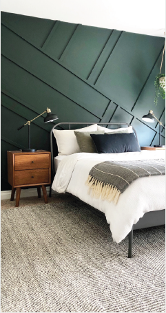 Bedroom with panelled green wall