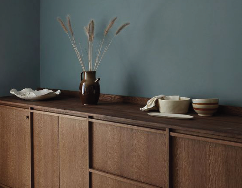 Oak sideboard against a blue-grey wall