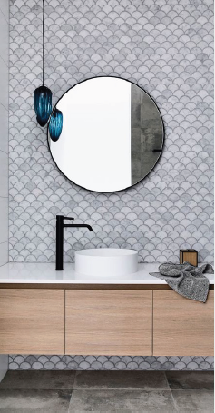 Bathroom with fish-scale tiles and round mirror